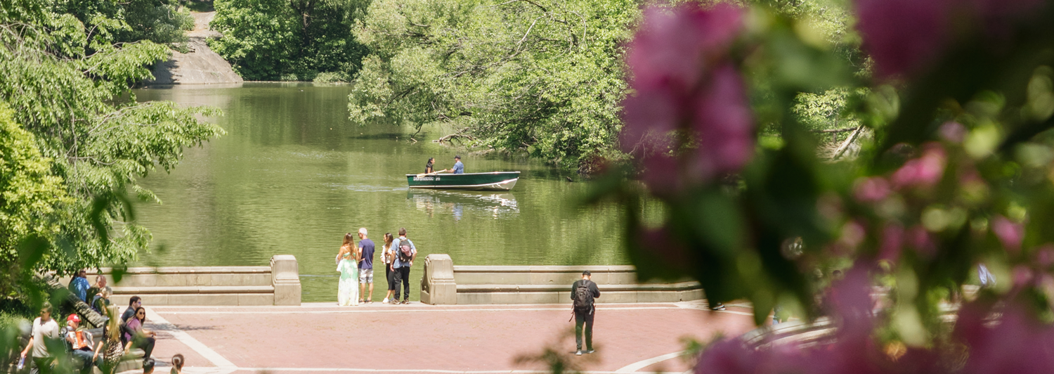 Central Park lake with people and boats.